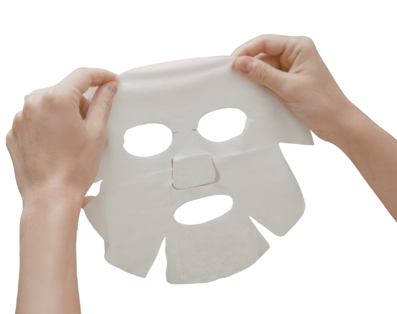 Person holding a white face mask against a white background