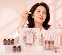 Woman using Ovaco Korean skincare with a display of Egg BP Cell Routine skincare items on a pink background