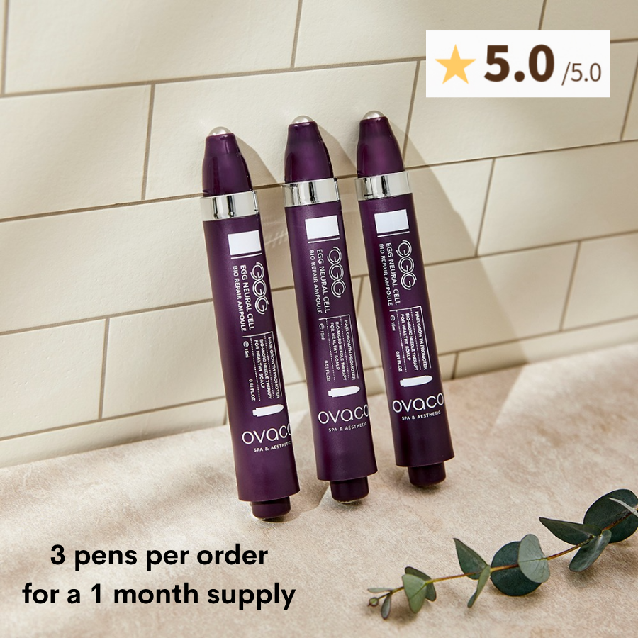 three Ovaco Biorepair Scalp Ampoule pens leaning on a beige tile background